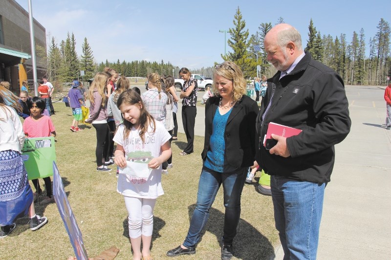 PC Candidate for Banff-Cochrane Ron Casey (right) and teacher Carla Murray listened as Grade 5 student Hope Olsen, 10, told them about the poster she did for her government