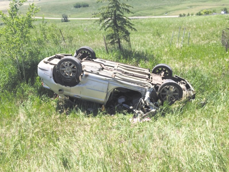 A man had to be extracted from a car after it rolled and crashed through a guard rail on Highway 566 and Symons Valley Road on June 27.
