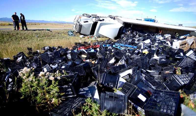 A tractor-trailer flipped over on the Hwy 22 exit from the Trans-Canada Sept. 29, spilling a load of B.C. fruits and vegetables.