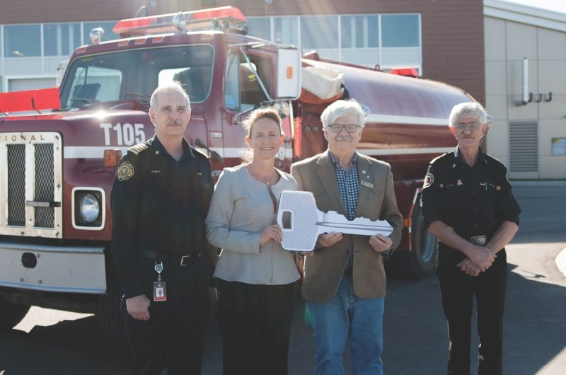 Rocky View Fire Services Chief Randy Smith (left) and Rocky View County Reeve Margaret Bahcheli donate a 1983 water tender to the Beiseker Fire Department on Oct. 14.