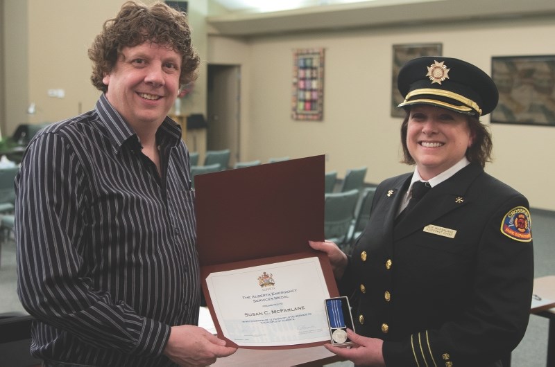 Assistant Fire Chief of the Crossfield Fire department Sue McFarlane, right, was awarded the Alberta Emergency Services Medal to honour 12 years with the force at the Feb. 2