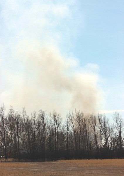 Residents and media were kept at a safe distance as a grassfire spread on a property near Delacour March 29.