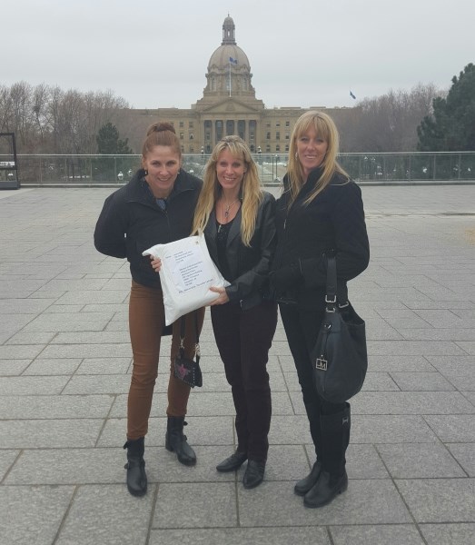 Chestermere residents (from left to right) Judy Dougan, Laurie Bold and Lara Sigurdsen delivered a petition signed by more than 5,000 residents concerned with council to