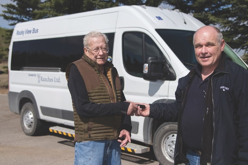 Rancher Jack Anderson (left) handed the keys of a brand new mid-sized bus to Rocky View Regional Handibus Society General Manager Paul Siller April 27.
