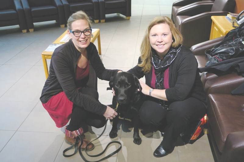 (Left) Mary Pieterse, learning support teacher and (right) Laura Gorr, child development advisor at Beiseker Community School brought facility dog Asia to the Dec. 1 meeting