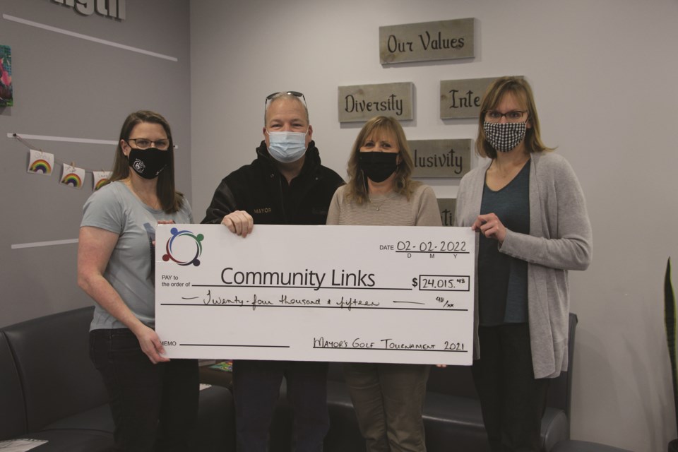Michelle Bates, chair of the Airdrie Health Foundation; Mayor Peter Brown; Brenda Hume, executive director of North Rocky View Community Links; and Laurie Jacob-Toews, community engagement manager at Community Links, pose with a cheque on Feb. 2. 