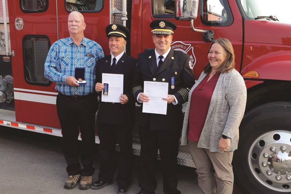 Crossfield Fire Department was host to a fire medal award night on Sept. 13. 
Awards were presented to retired Lt. Bob Ross, Capt. Mark Lang, Chief Ben Niven, and Capt. Justin Fuhriman (not pictured) with Crossfield Mayor Kim Harris presenting alongside Chief Niven. 