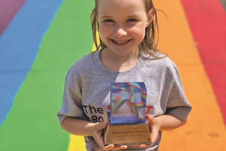 Love of Dance Award recipient Charlotte Murley poses with a custom-designed trophy inspired by five-year old Quinn Kerber who died in a tragic accident last year.