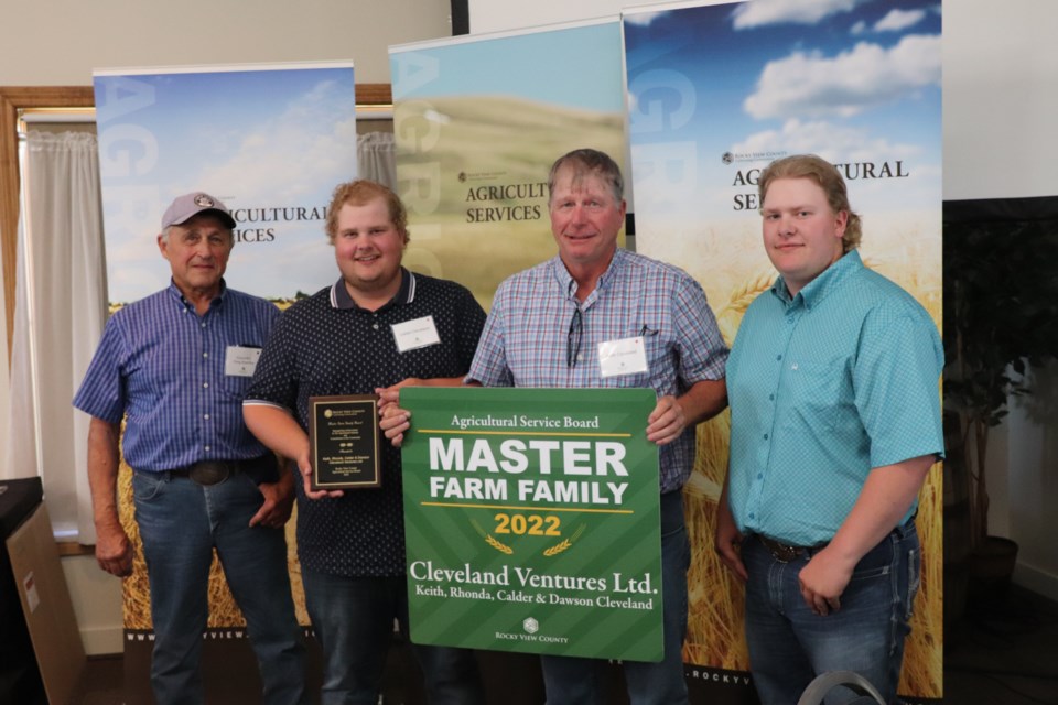 Rocky View County (RVC) awarded the Master Farm Family award for 2022. From left to right, RVC councillor Greg Boehlke, Calder Cleveland, Keith Cleveland, and Dawson Cleveland.