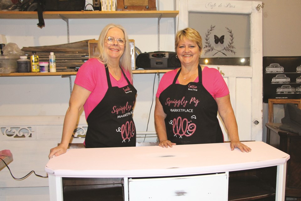Airdrie residents Sandi Sketchley (left) and Cassie Bishop (right) have been refinishing furniture to showcase at the Squiggly Pig Marketplace this June. 