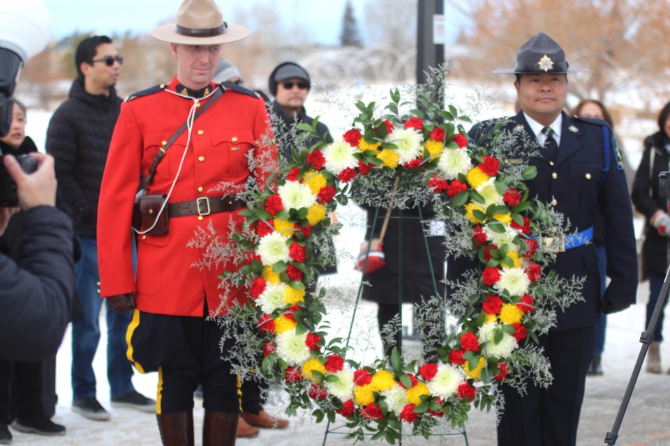 Colour guard from RCMP and Alberta Sheriffs help bring in the wreath to honour Dr. Jose Rizal at the Rizal monument in Nose Creek Park at a previous year's event.