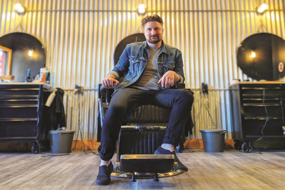 Glenn Kelly sits in a chair at his barbershop in Bragg Creek. Bragg Creek Barber Co. opened to the public on June 1. 