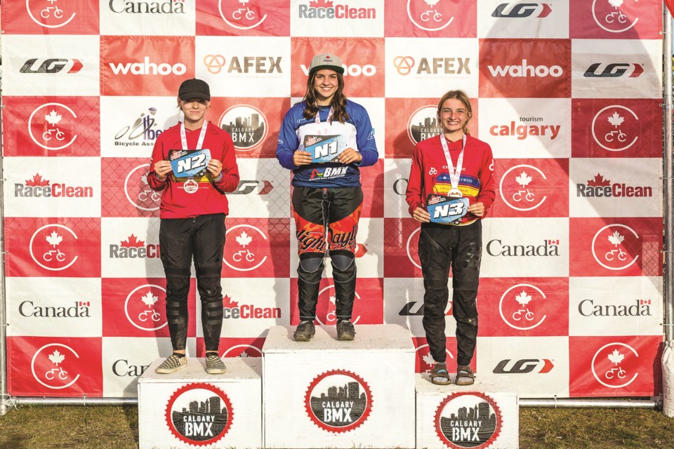 Abygale Reeve, center, smiles after being crowned Canada's national champion, following a race that was held in Calgary this year. 