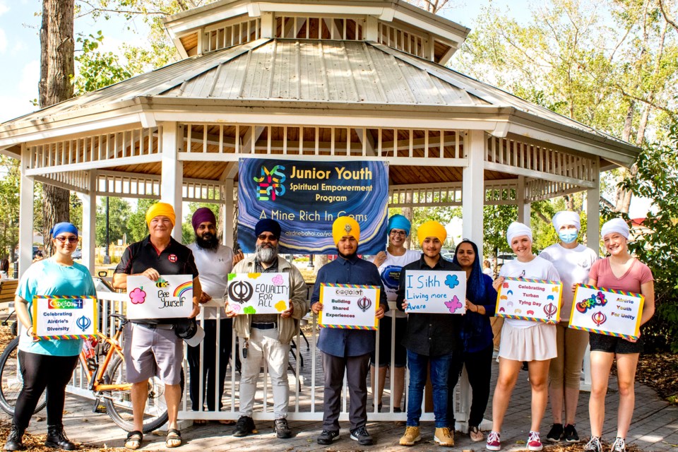 The Junior Youth Spiritual Empowerment Program hosted Tie-A-Turban at the Airdrie Farmers Market on Aug. 24. Mayor Peter Brown (second from the left) sported a yellow turban to help promote diversity and cultural awareness. 