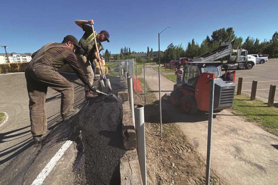 The scorching weekend heat didn't stop locals from helping the BMX track get the fix they needed after the collapse. Photo Submitted/For Airdrie City View