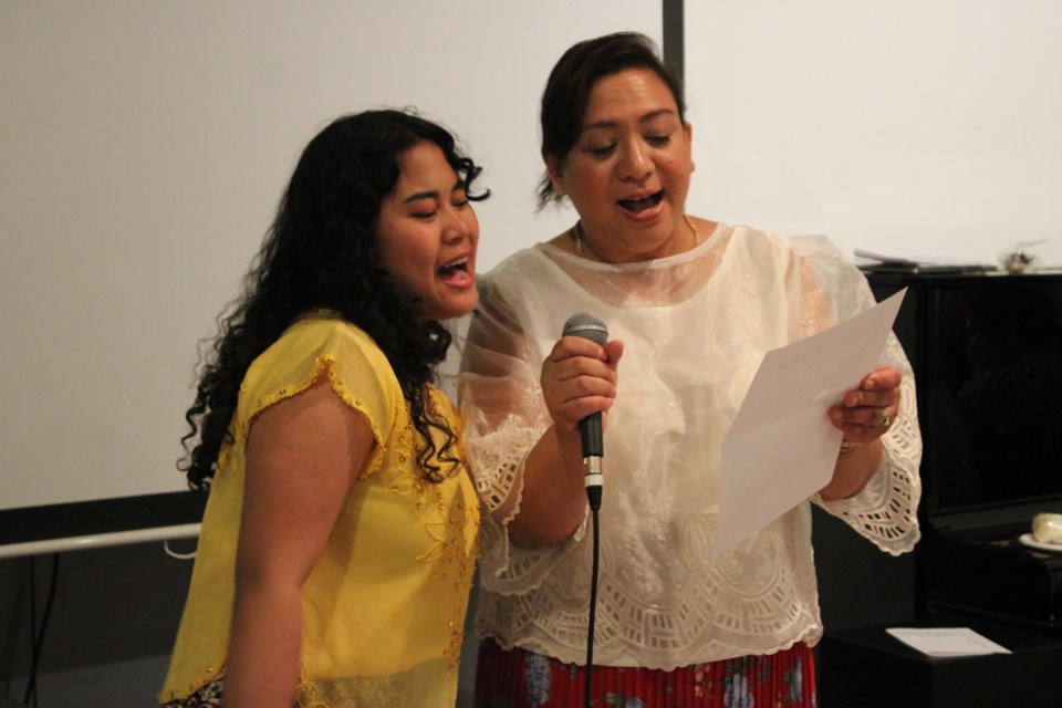 Elysia Cruz and Ovvian Castrillo-Hill sing a traditional song together from the Philippines.  
