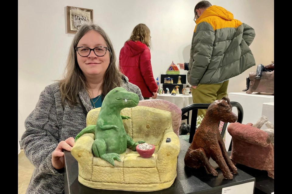 North Peace Potters Guild president Lori Phillips with one of her works at the guild's new exhibit.