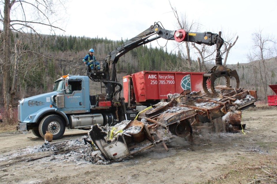 The burned-out husk of an RV makes its final exit from the Beatton River thanks to ABC Recycling, May 4, 2022.