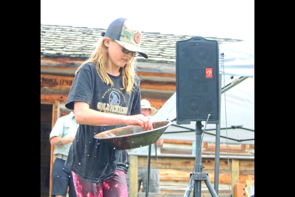 10-year-old Frankie Barrette finds her gold nugget during the A-class competition at the World's Invitational Gold Panning Championships in Taylor July 31