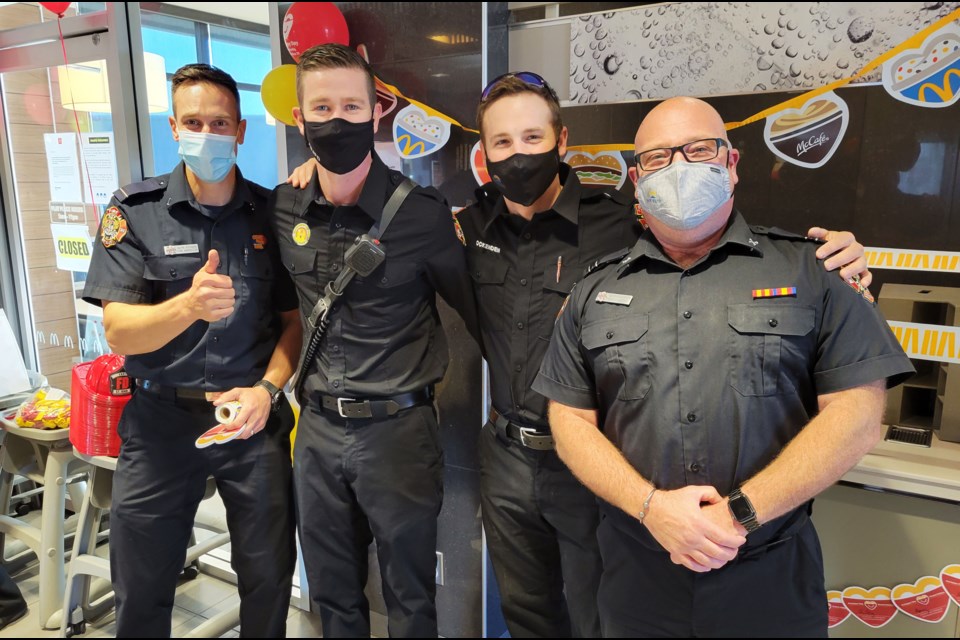 Fort St. John firefighters Alyn Stobbe, Chris St. Cyr, Jayden Ockenden, and Marco D'Agostino handing out stickers and accepting donations at McHappy Day. 
