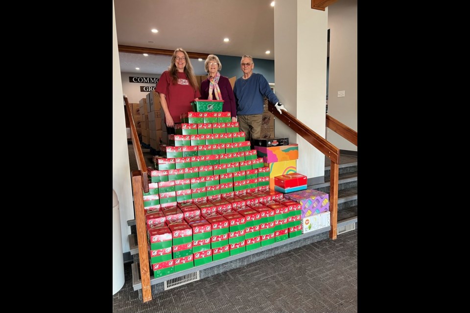 Operation Christmas Child local co-co-ordinator Crystal Holden with her parents, displaying their 115 shoeboxes packed with help and donations from friends (Supplied)
