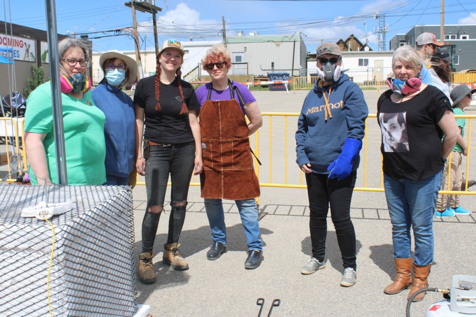 North Peace Potters' Guild members held 'raku' kiln firing demonstrations all day, inviting residents to make their own pottery. 

Pictured here: Lori Phillips, Sherry Petryshyn, Jordan Munro, Carla Hafner, Barb Wagner, and Karla Lambert. 