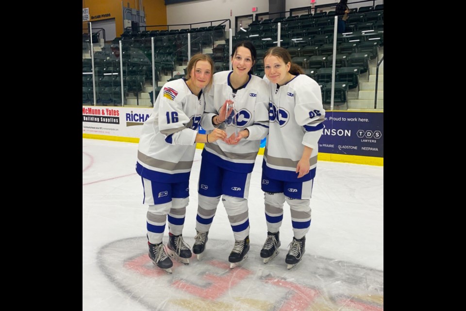 Northern Capitals teammates Hailey Armstrong, Keagan Goulet, and Brooklyn Hutchings celebrate together after winning the 2021 Western Regional Women's U18 Championship, November 6.