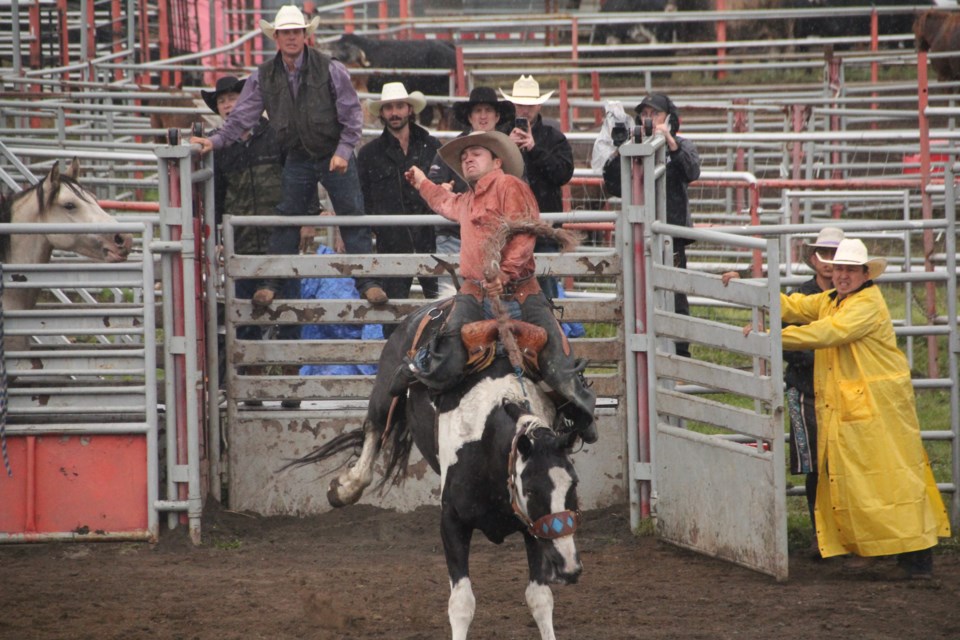 Colton Crook of Fort St. John hangs on to his horse for dear life on Saturday, before winning the saddle bronc event on Sunday at the 2021 Halfway River Rodeo.
