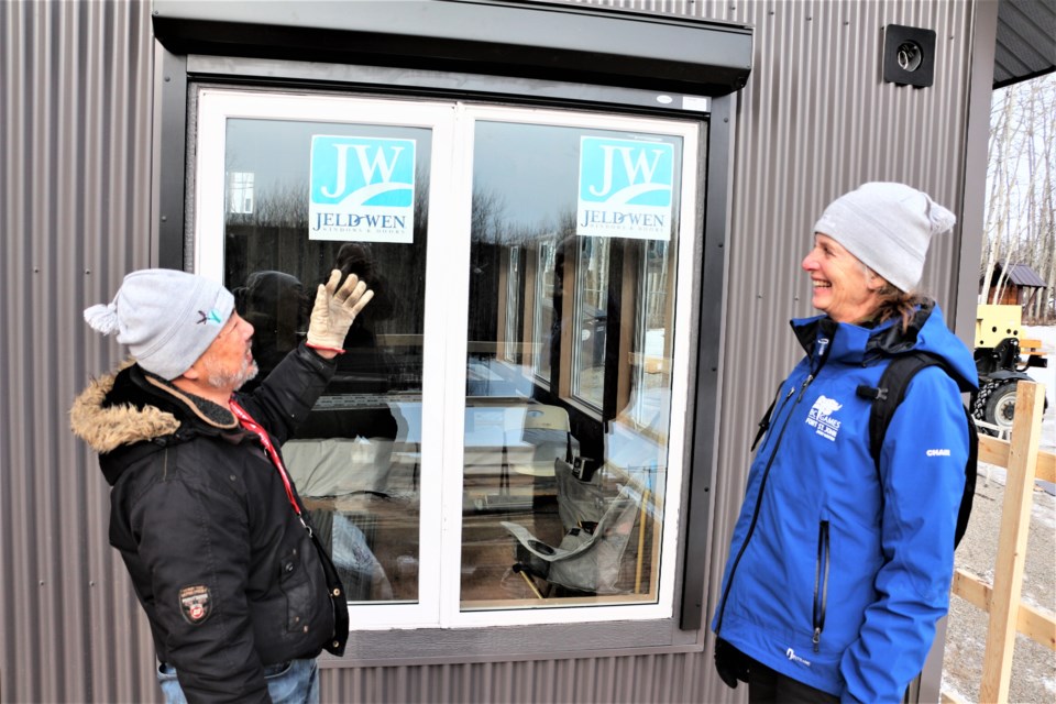 Bruce Kosugi and Eliza Stanford of the Whiskey Jack Nordic Ski Club show off the new lodge under construction at Beatton Provincial Park.