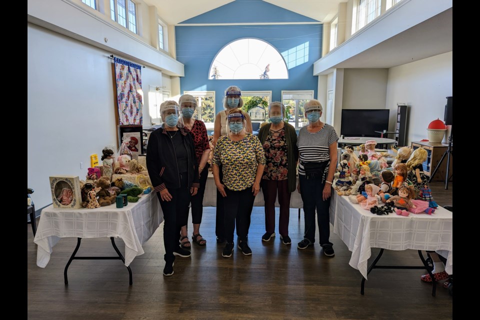Members of the Doll Club of Edmonton at Shepherd’s Care Kensington last October, where they presented dolls and ‘stuffies’ to residents as part of their Memory Project for people with Alzheimer’s. Photo supplied.