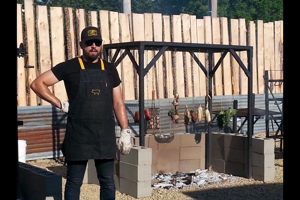 Pitmaster Peter Zukiwski shows off the grills and foods he's cooked up for The Old Red Barn's Farm to Flame Experience. Photo: Lucy Haines