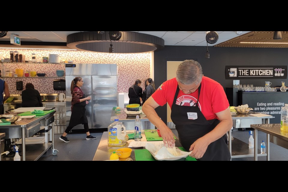 Ricky Pachakes shows off his focaccia during a class at The Kitchen, Aug. 17, 2023, at the Edmonton Public Library Stanley A. Milner branch. Photo David Ryning.