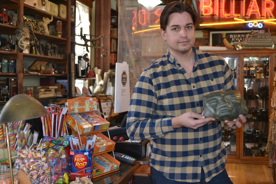 Alex Archbold holds an ancient Mayan jade mask, dating back possibly between the Ice Age and 500 CE. Photo: Lucy Haines