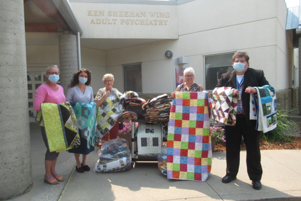 In a previous campaign, staff at Ponoka Hospital accept quilts for patients at the Ken Sheehan psychiatry ward. Photo supplied.