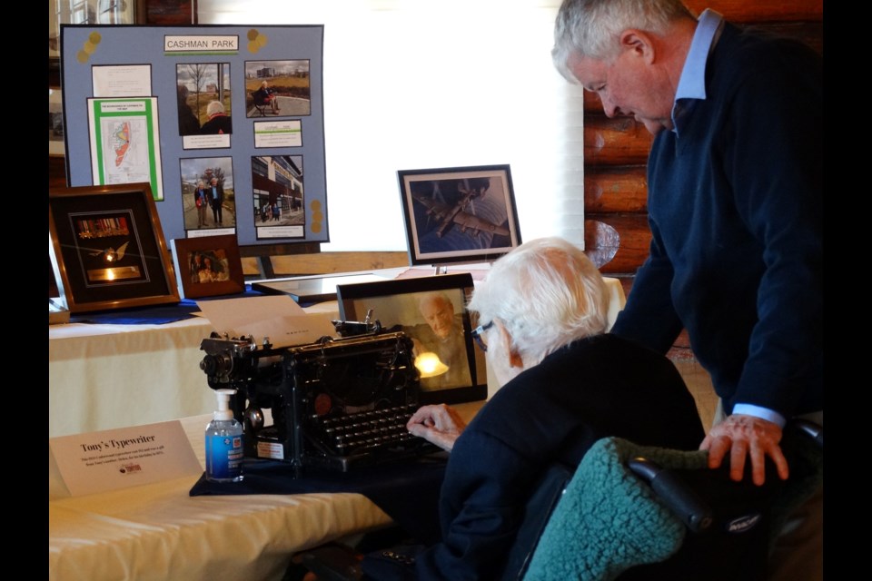Tony Cashman taps a few keys on his 1924 Underwood typewriter at his 100th birthday party at Pioneer Cabin in Edmonton in late April. Looking on is his youngest son, Paul. Tony's mother's, Helen, bought the typwriter as a birthday gift for $12 in 1935.  Photo supplied