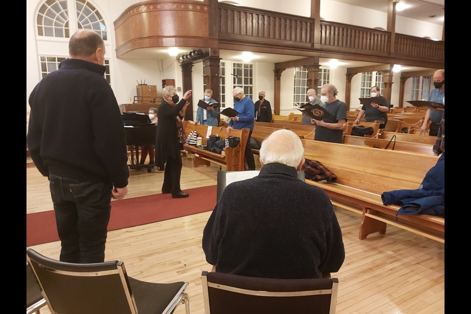 With choir artistic director Elizabeth Anderson, members of the Edmonton Swiss Men’s Choir warm up with the anthem Ode an Gott at a February rehearsal. The choir has re-launched rehearsals after an almost two-year hiatus during the pandemic. Photo: Kate Wilson