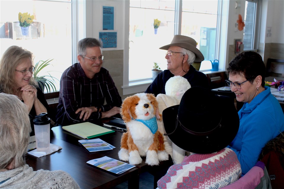 Maria Heringa (left) attends a Conversation Cafe at Lakeshore Manor in Chestermere. (Left, Don Montpetit who helped launch the cafe in town, is joined by Alan Rae and Helen Puls of Conversation Cafes. Photo: Sylvia Cole.