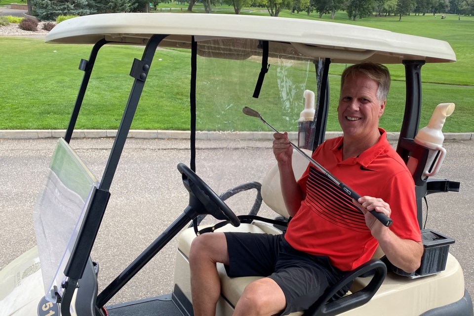 Medicine Hat Golf and Country Club GM Cam Jacques displays one of the made-in-Edmonton vinyl dividers (golfsafely.com) that have been installed on 15 carts at the club. Photo supplied.