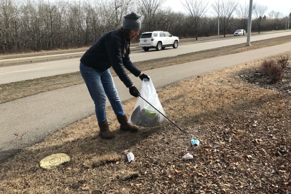 Linda Poignant picks up masks in the Westboro neighbourhood of Sherwood Park on March 27.