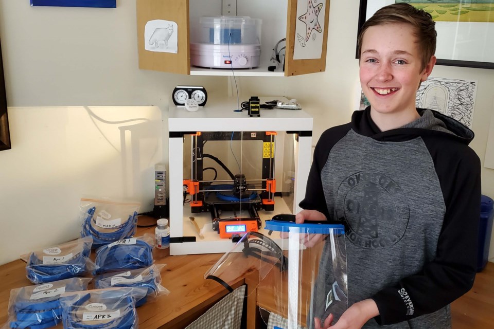 Owen Plumb, 13, of Okotoks, has helped make more than 100 face shields, which he hopes to distribute to health-care workers in the Foothills community. (Photo submitted)