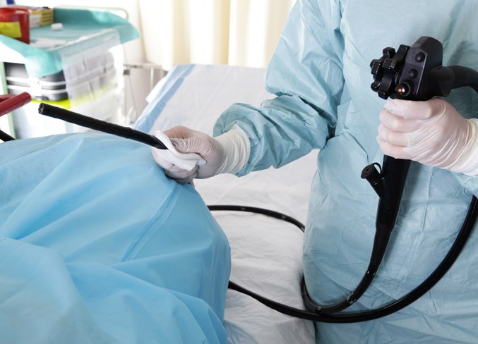 Doctor holding endoscope before colonoscopy