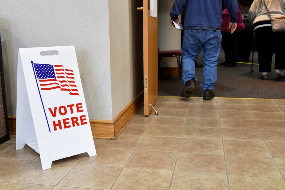 people-walking-into-a-polling-place-on-election-da-YQFHAB8