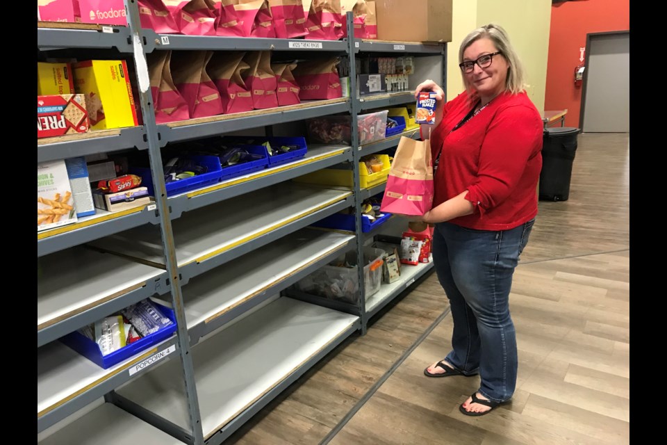 Army veteran Melanie Harris displays the child's pack for a food hamper available through the Veterans Association Food Bank facility in Edmonton. The unique organization offers food and other resources to struggling veterans. Photo: Gary Poignant