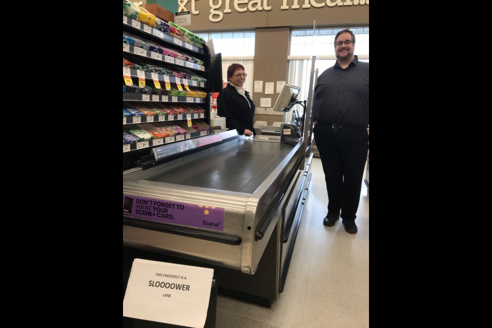 Cashier Carol Cardinal and owner/operator Jerry MacLachlan say customers at the Belmont Sobeys enjoy taking their time in the store's slow lane. Photo: Gary Poignant  