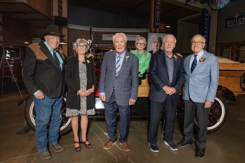 The 2023 Top 7 Over 70 recipients: (left to right): John Scott, Janice McTighe, Dr. Benno Nigg, Tania Willumsen, Mogens Smed and Ron Ghitter. A photo of the seventh winner, Tom Jackson, is behind the group members, who were photographed at Heritage Park's Gasoline Alley. Azin Ghaffari photo; courtesy Postmedia.