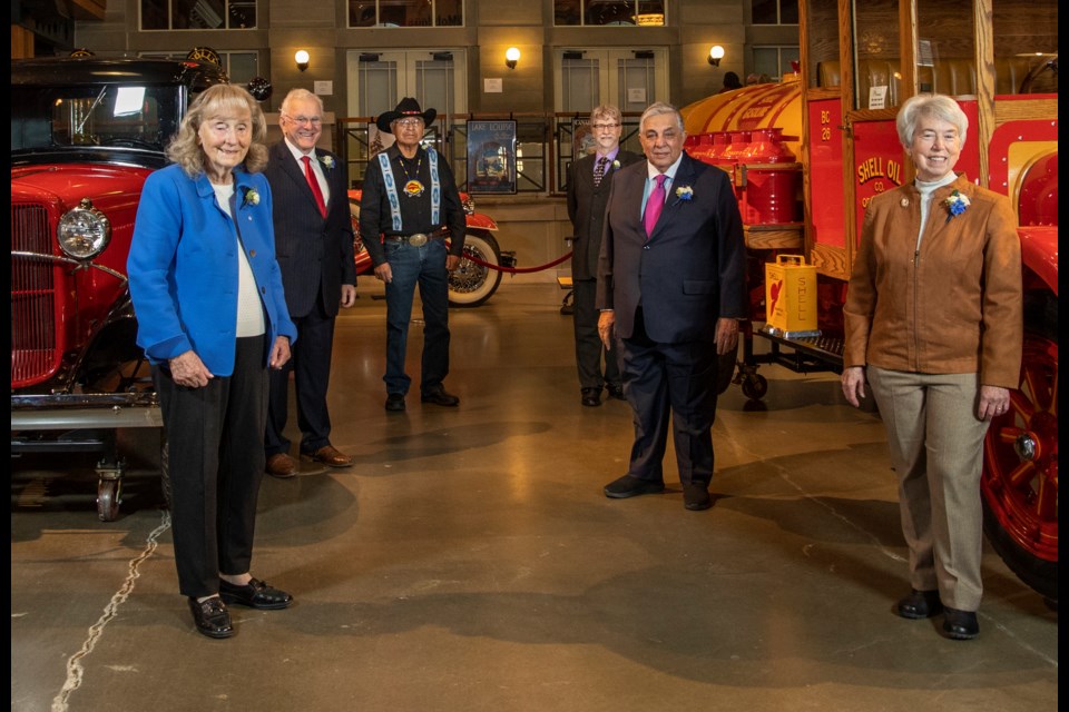 Top 7 Over 70 - 2021 winners (from left) Margaret Southern, Murray McCann, Miiksika'am (Elder Clarence Wolfleg), Louis B. Hobson, Sherali Saju, and Bonnie Kaplan in Gasoline Alley at Heritage Park in Calgary, Missing is Don Taylor. Photo: Gavin Young
