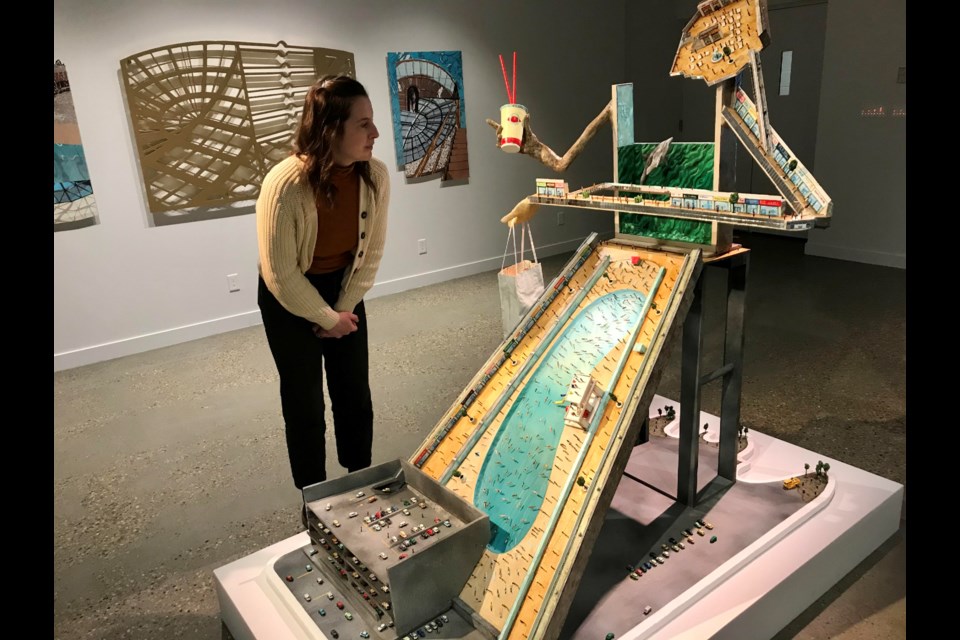 Carolyn Jervis, director of the John & Maggie Mitchell Art Gallery, checks out 'Self-Contained' by Alberta artist Jude Griebel at THE MALL exhibition. Gary Poignant photo 