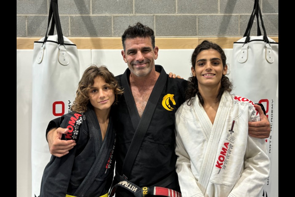 Brothers Santiago (left) father and coach Martin, and Mathieu Peyrou at Cavalo Martial Arts Aurora.