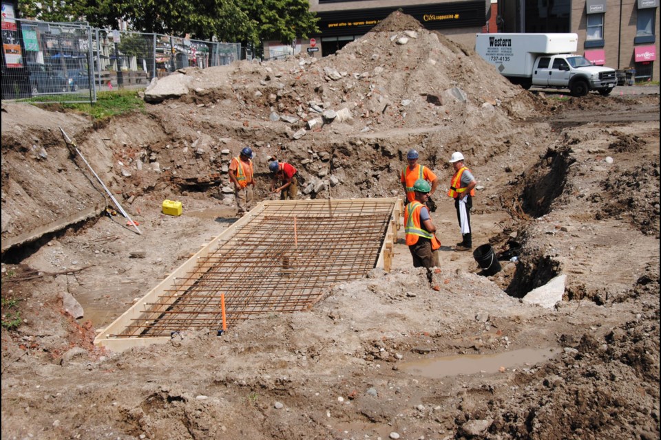 Construction crews work on a new foundation for the cenotaph, which will be relocated to the bottom of Owen Street.