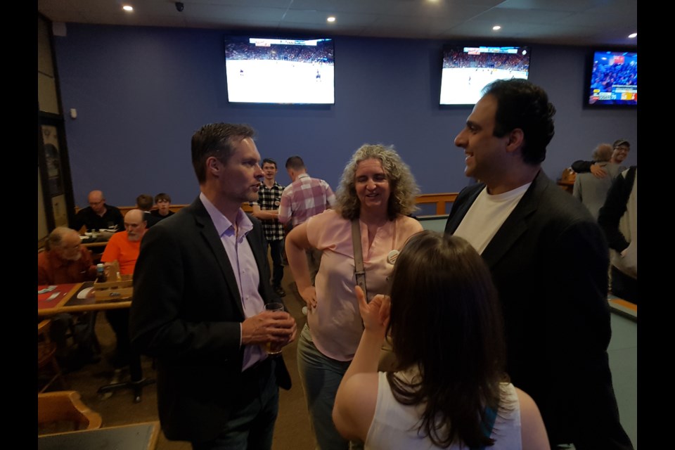 Pekka Reinio (left) chats with supporters after the results of the election. Shawn Gibson for BarrieToday